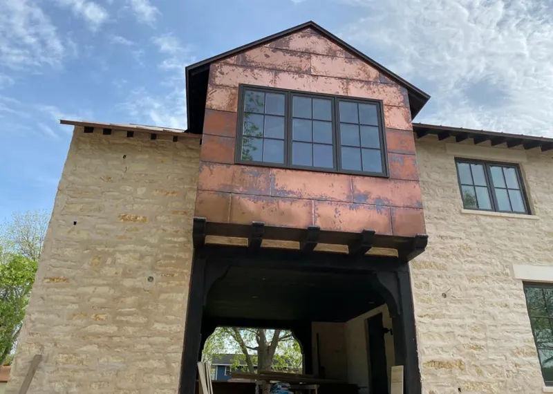 Copper metal panel facade on a stone building for Metal Roof Coating in Marble Falls